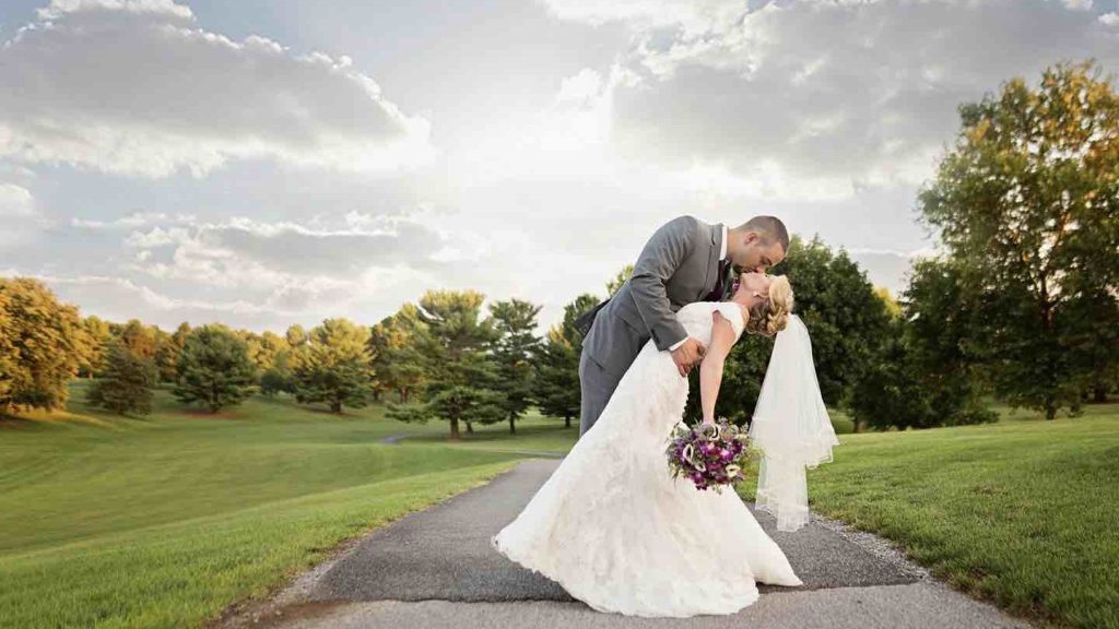 couple kissing on the course