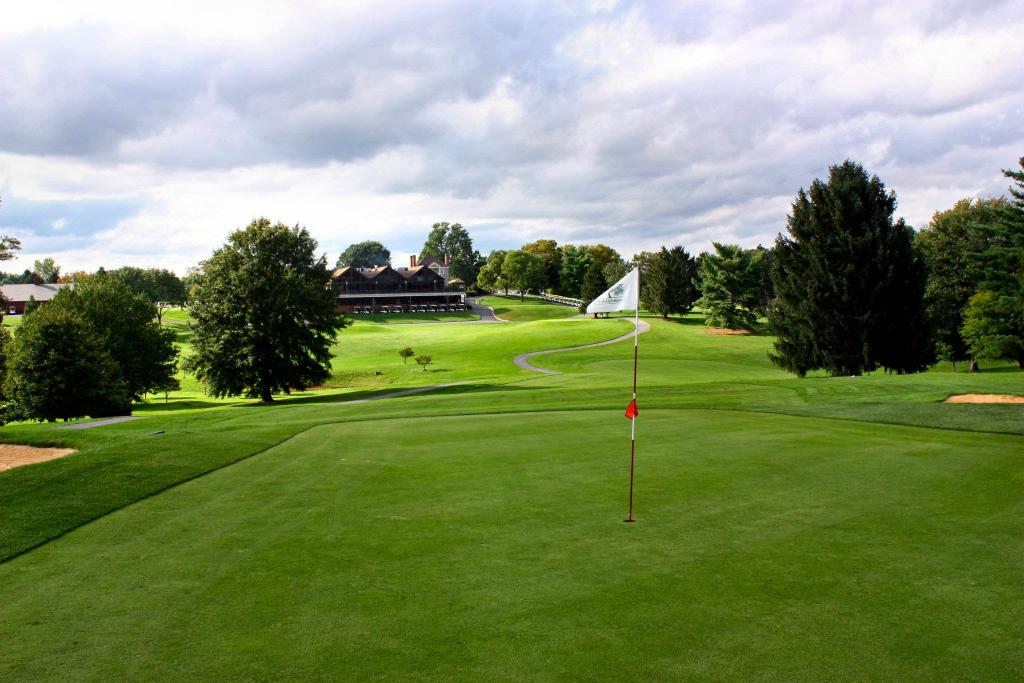 view of green with clubhouse in the background